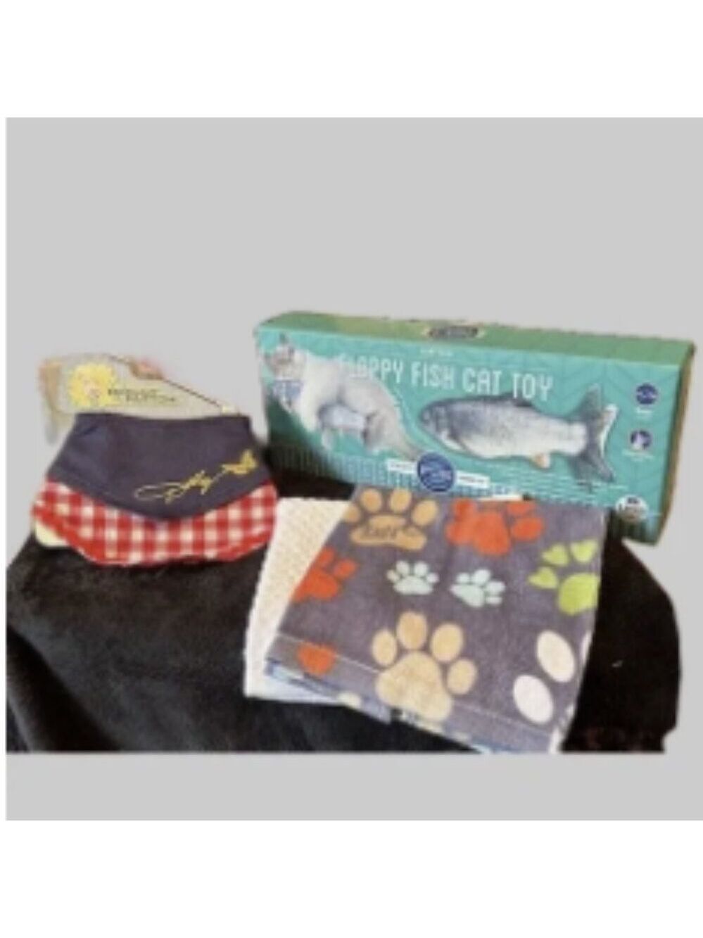 electric floppy fish cat toy, paw print towel, and a cute bandana
